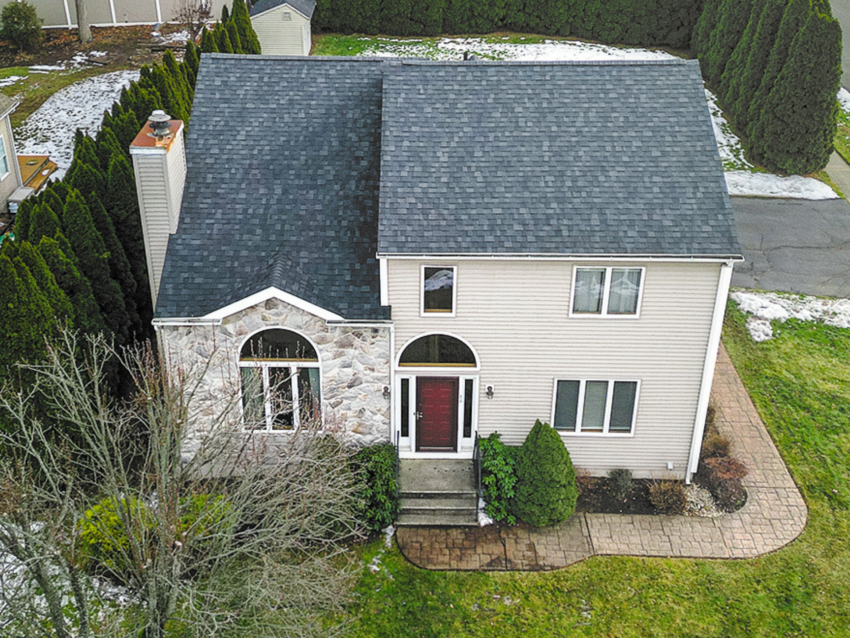 After: Aerial view of a stunning Owens Corning Duration Shingles roof installed on a beige colonial home in Newington, CT — clean lines, durable protection, and timeless curb appeal.
